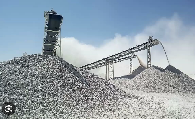 Natural gypsum stockpiles and conveyor